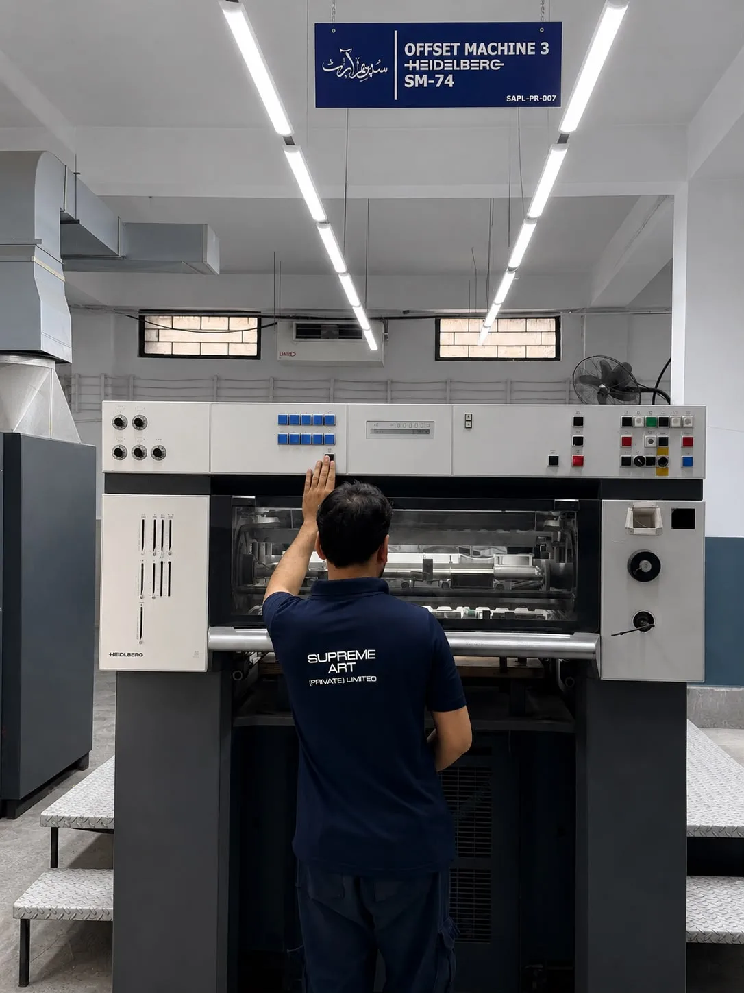 Operator at the controls of Offset Machine 3, a Heidelberg SM-74.